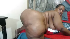 A cute couple enjoys on the couch in a passionate pose